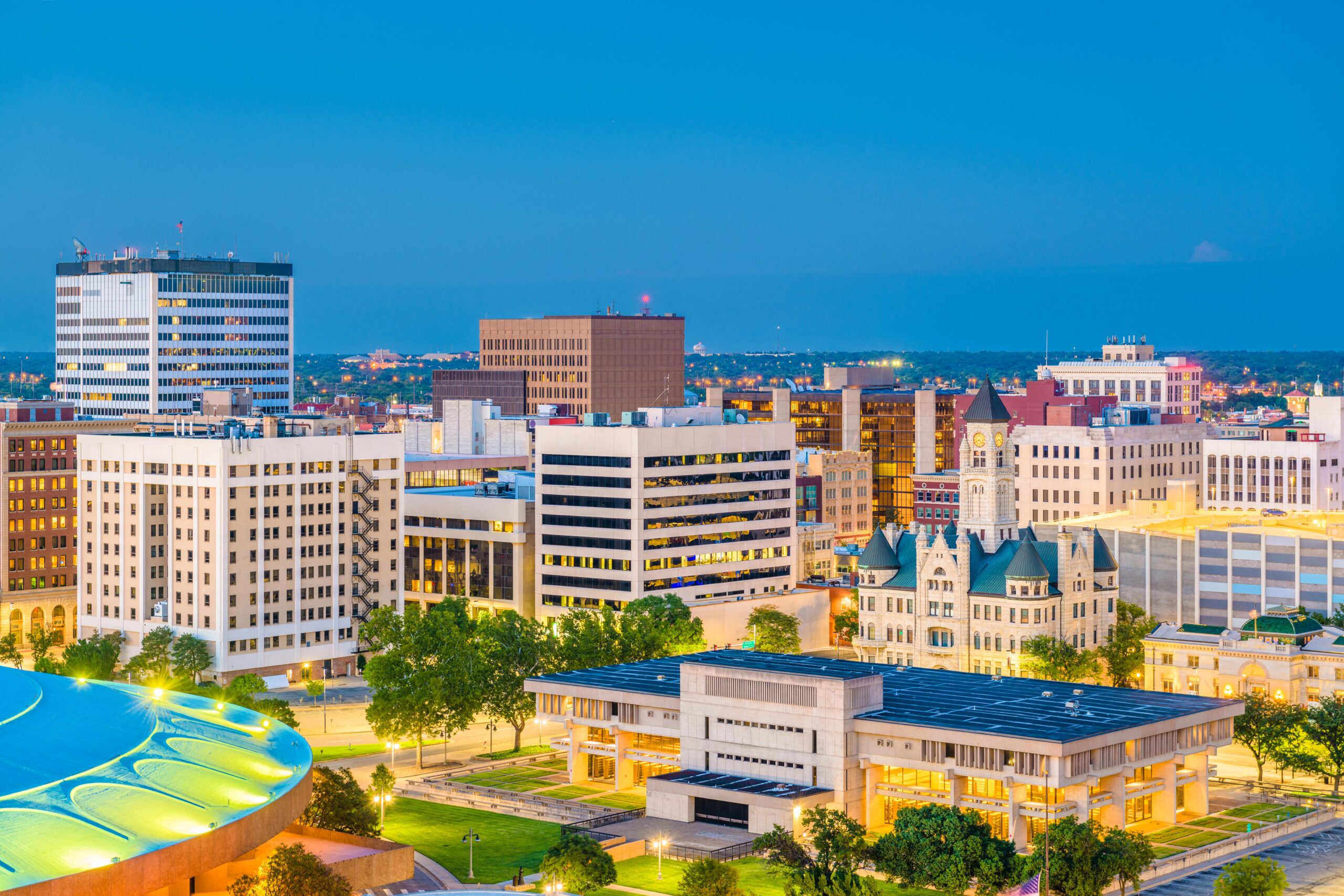 Wichita downtown skyline at dusk with historic buildings.